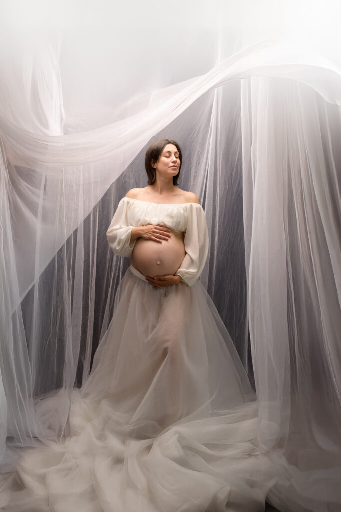 photo couleur femme enceinte sous des voilages blancs seance photographe grossesse studio gard aigues mortes